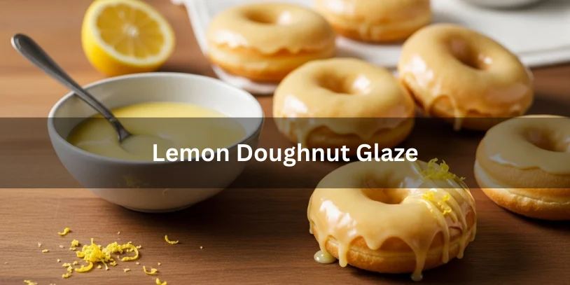 Small bowl of glossy lemon glaze with freshly baked doughnuts partially coated, garnished with lemon wedge and zest.-lemon doughnut glaze