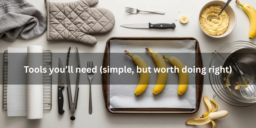 Flat lay of tools for oven-ripening bananas, including a parchment-lined baking sheet with bananas, oven mitts, tongs, knife, fork, mixing bowl, and cooling rack.-ripen bananas in the oven 