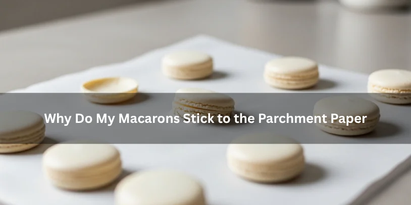 Macaron shells on parchment paper with a few sticking to the surface, showing the difference between clean release and sticky bottoms under soft natural lighting.-why do my macarons stick to the parchment paper