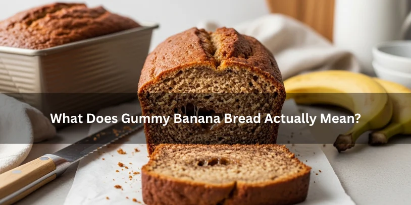 Banana bread loaf with a sticky dense glossy crumb and wet-looking center, illustrating what gummy banana bread means under soft natural lighting.-why is my banana bread gummy 