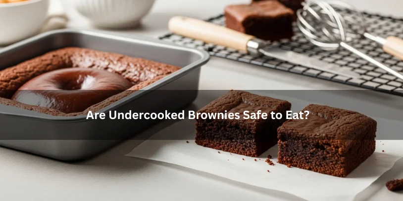 Brownie pan with a soft glossy center beside cut pieces showing set and undercooked texture, illustrating whether undercooked brownies are safe to eat under soft natural lighting.-how to fix undercooked brownies that have cooled 